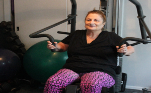 senior citizen using weight machine