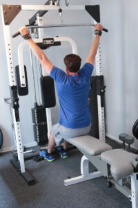 man using weight machine