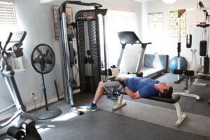 man laying on weight bench