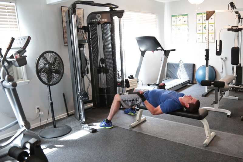 man laying on weight bench