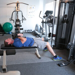 man laying on weight bench