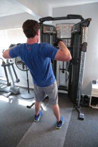 man standing using eight machine