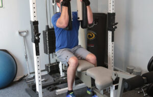 man using weight machine