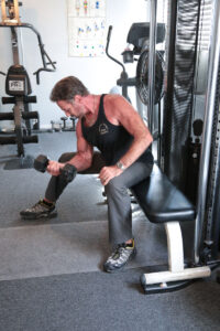 man lifting dumbbells